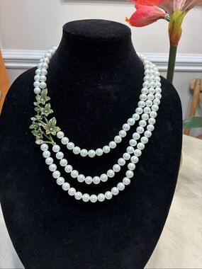 White Beaded Triple-Strand Necklace with Green Leaf Accent by Heidi Daus.